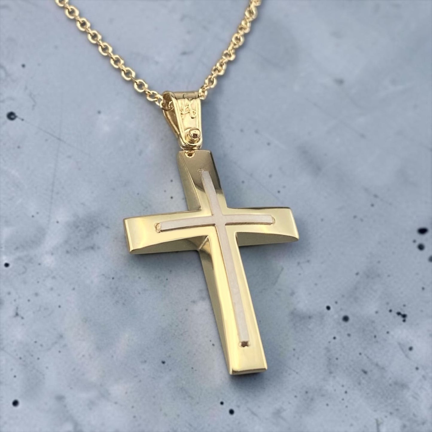 A 14K yellow gold men's cross pendant featuring a polished white gold cross inlay.