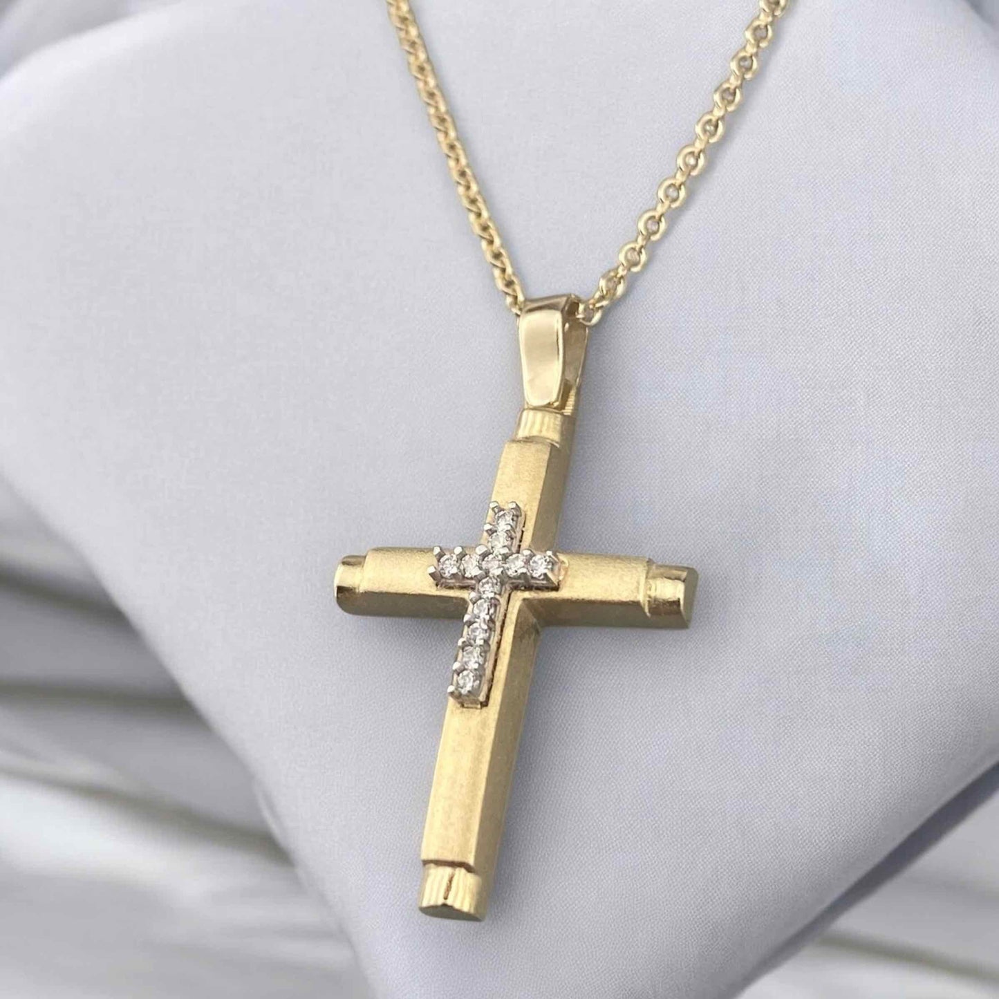 14k yellow gold women's cross pendant, featuring a sleek polished design with a central vertical row of brilliant zirconia stones.