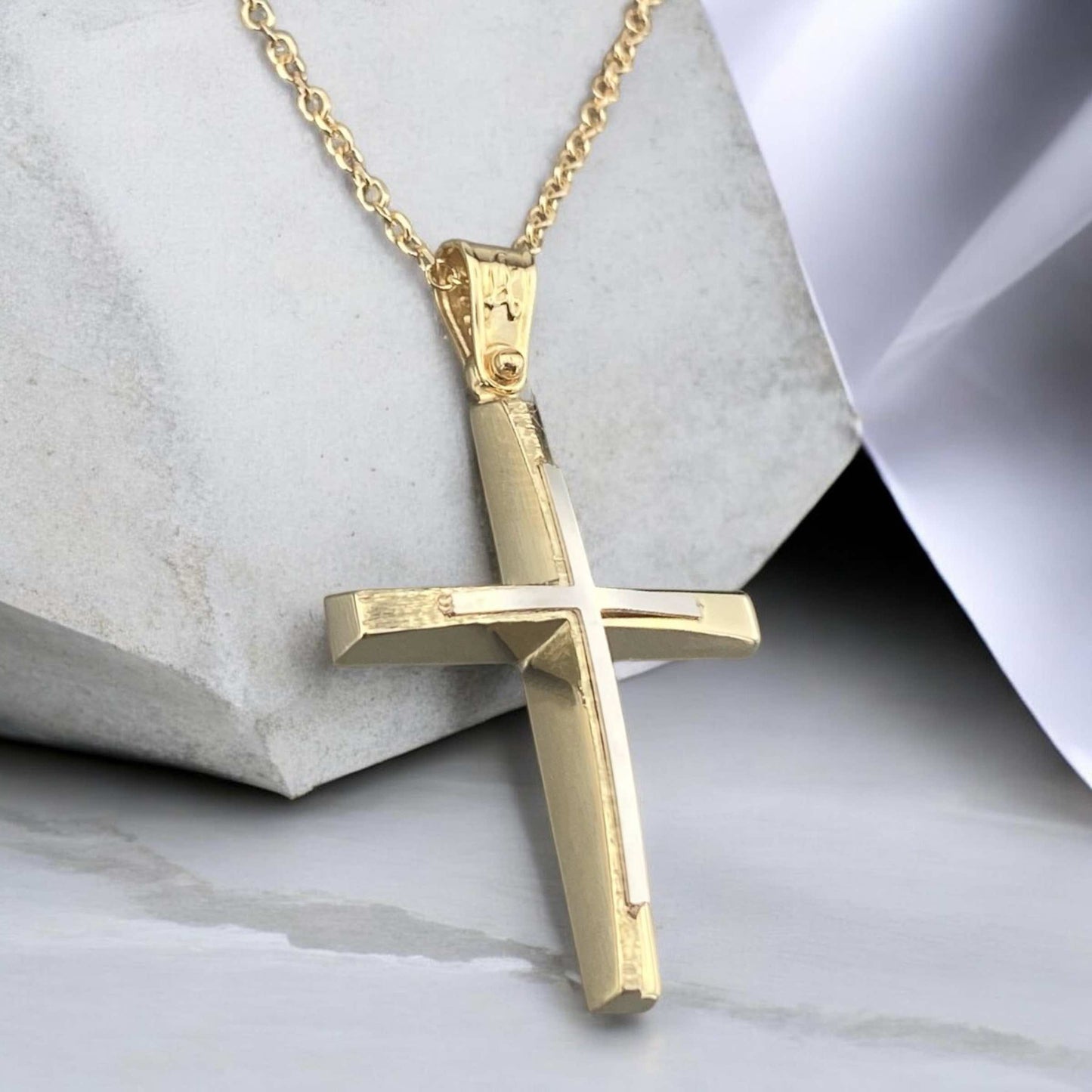 A 14K yellow gold men's cross pendant featuring a white gold inlay, combined with a unique matte and polished finish design.