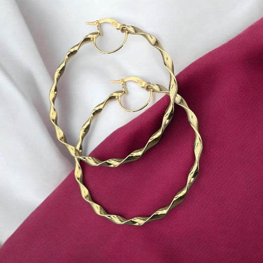 Stylish 14k yellow gold large hoop earrings featuring a twisted textured design with an elegant polished finish.