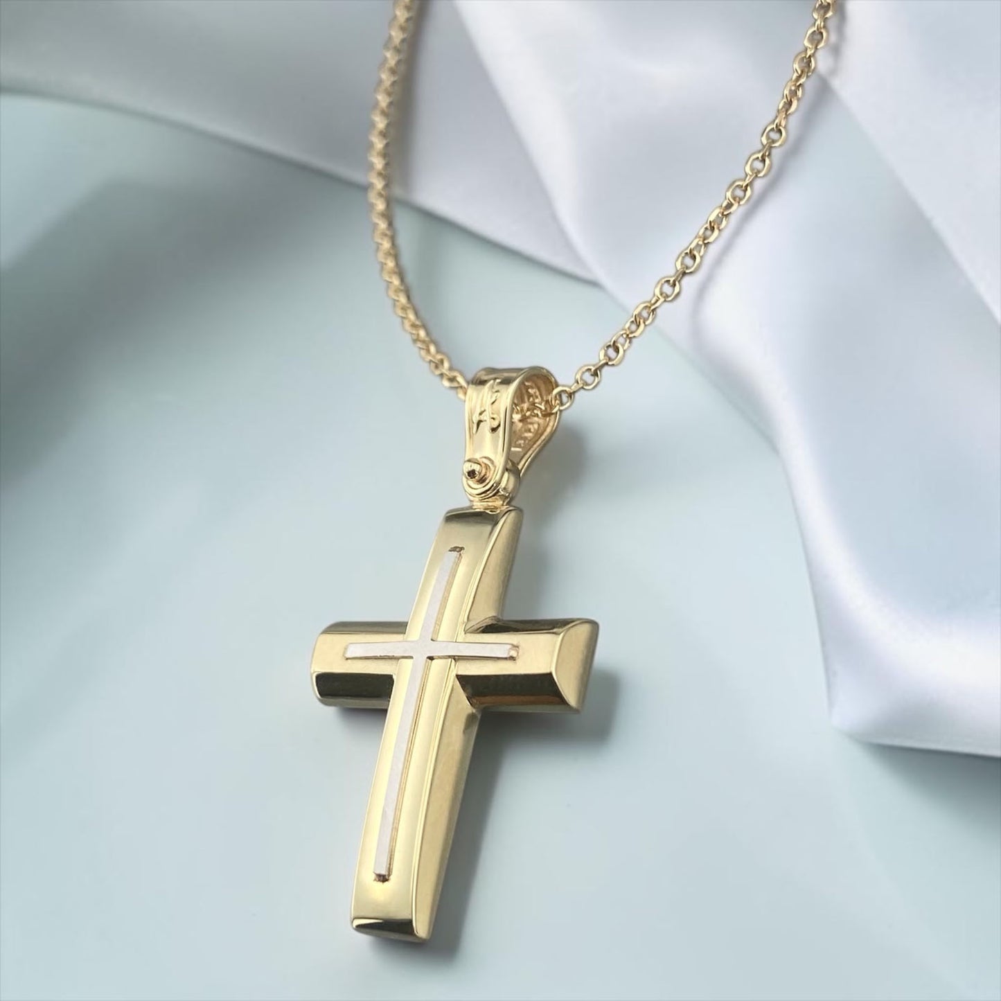 A 14K gold men's cross pendant featuring a unique design with a matte horizontal bar and a polished vertical bar.
