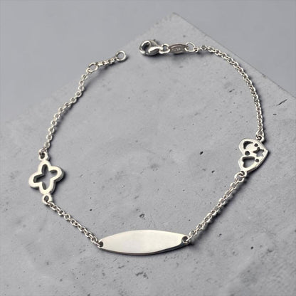 Children's 14k white gold ID bracelet featuring a clover charm and a heart charm with star cut-outs by Glamour Dainty Jewels, delicate baby jewelry.