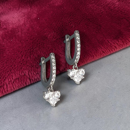 Elegant 14k white gold drop earrings featuring a sparkling cluster of cubic zirconia, accented by a zirconia-paved hoop mechanism.