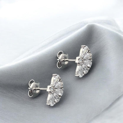 Elegant 14k white gold stud earrings featuring a fan-shaped design with sparkling baguette and round crystals.