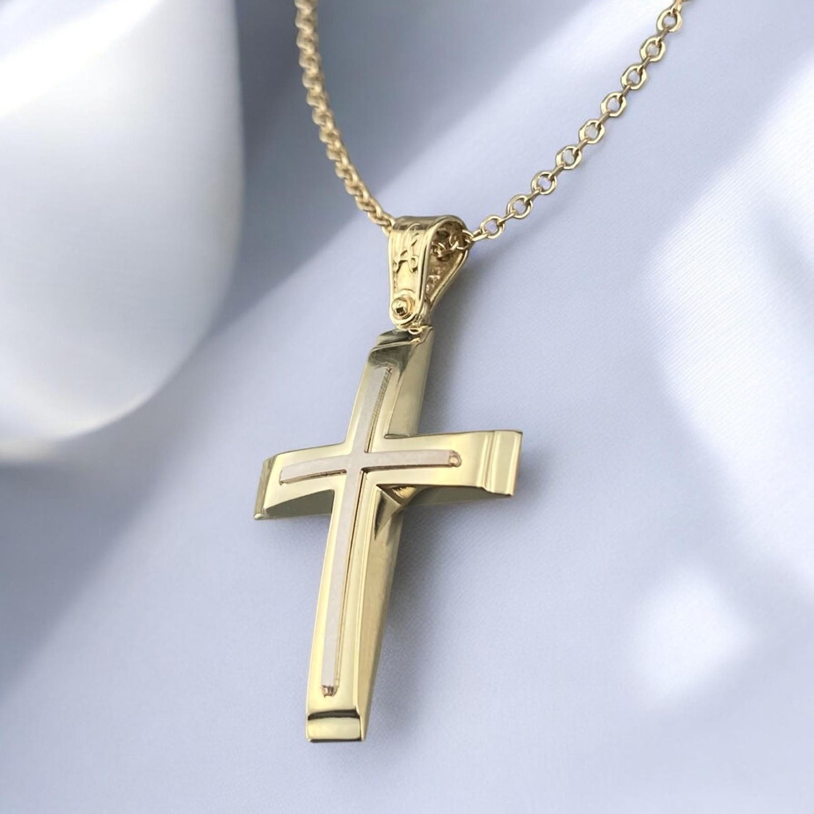 A 14K yellow and white gold men's cross pendant featuring a polished inlay cross design.