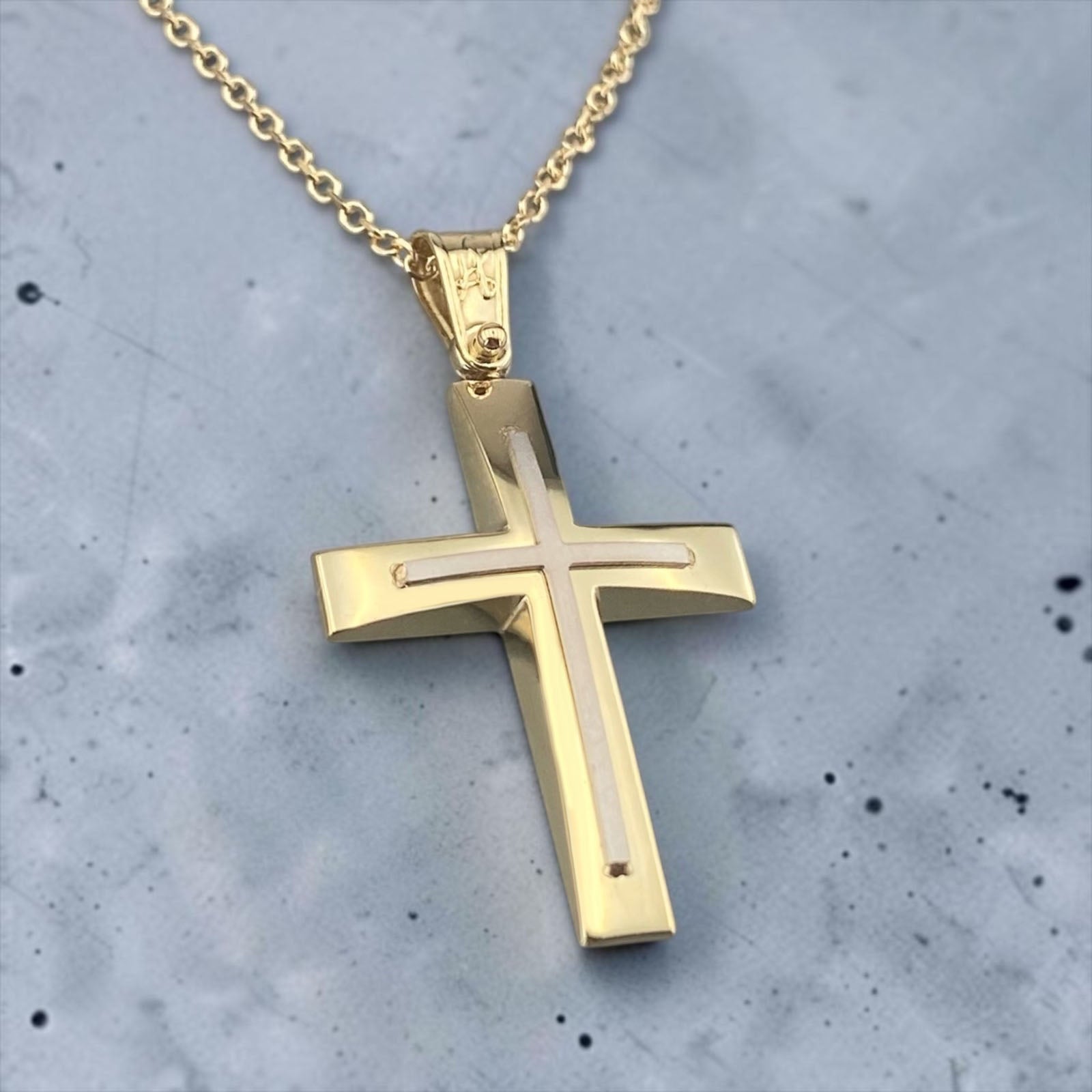 A 14K yellow gold men's cross pendant featuring a polished white gold cross inlay.