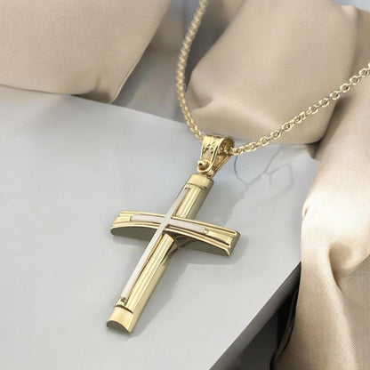 A detailed view of a 14K yellow and white gold men's cross pendant featuring a polished inlay cross design