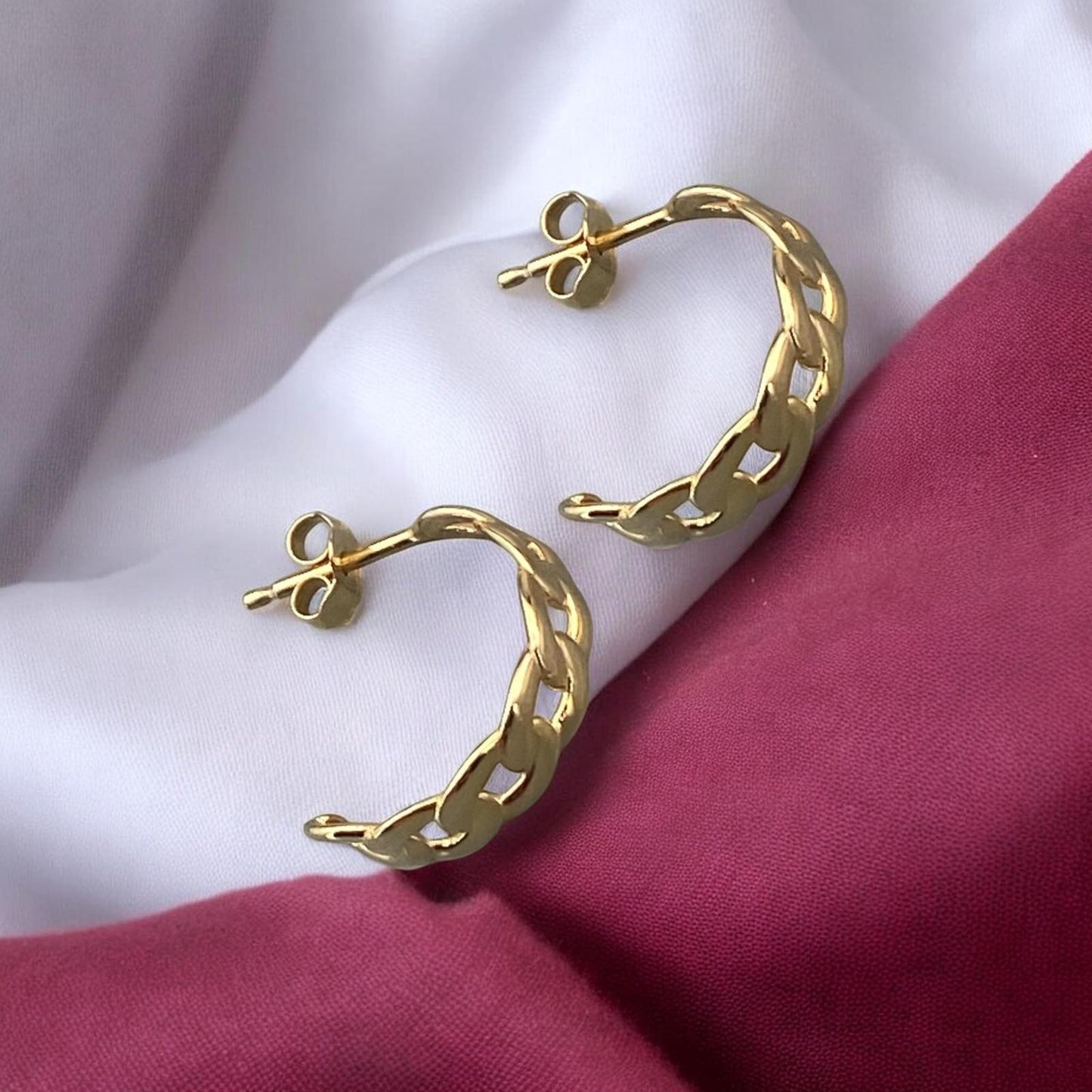 Stylish 14k yellow gold half-hoop earrings featuring a sophisticated chain link design with a high-polished finish.