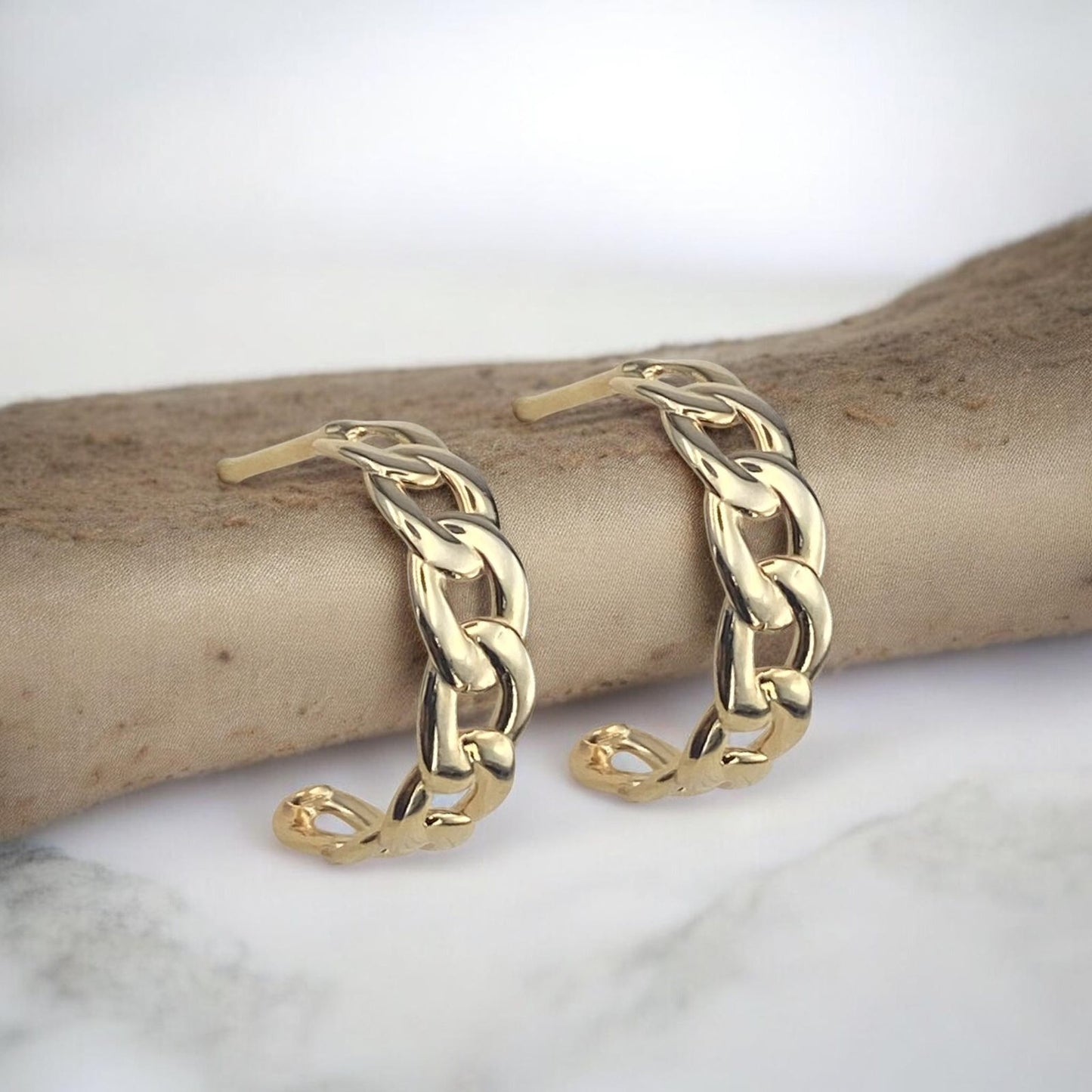 Stylish 14k yellow gold half-hoop earrings featuring a sophisticated chain link design with a high-polished finish.