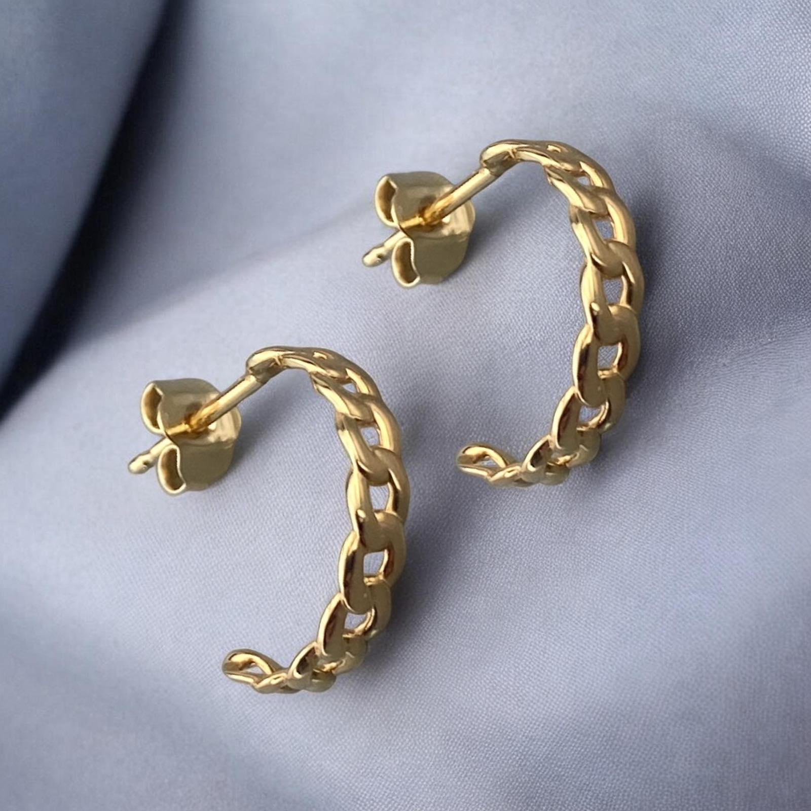 Stylish 14k yellow gold huggie hoop earrings featuring a bold chain link design with a polished finish.