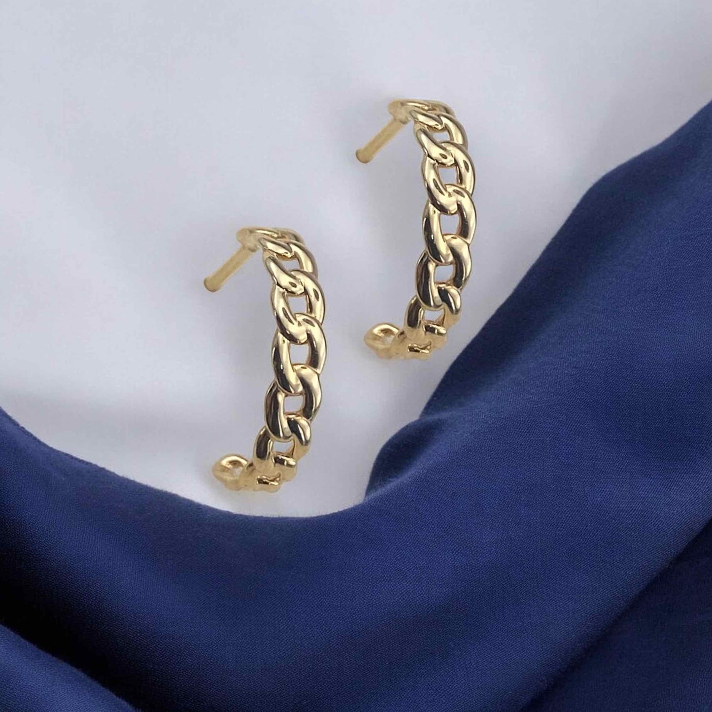 Stylish 14k yellow gold huggie hoop earrings featuring a bold chain link design with a polished finish.
