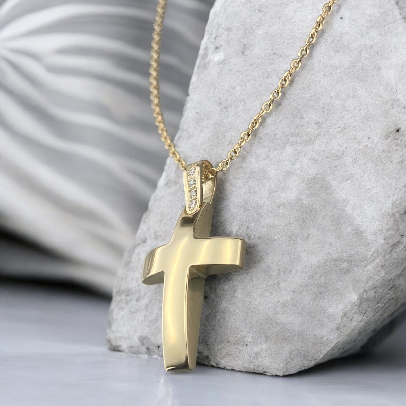 14k yellow gold cross pendant for women, featuring a smooth polished surface and sparkling zirconia stones set on the bail.