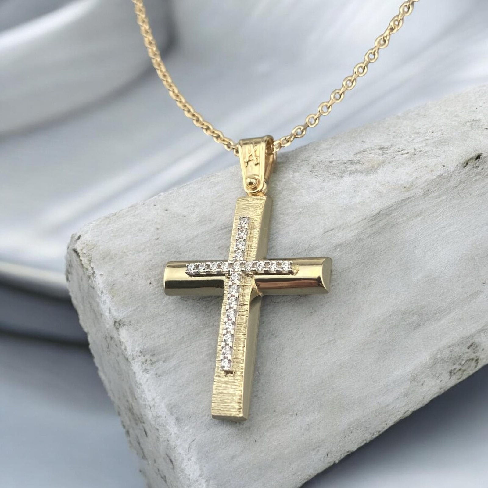 14k yellow gold cross pendant for women, featuring a high-polish finish with shimmering pave-set zirconia stones at the tips and on the bail.