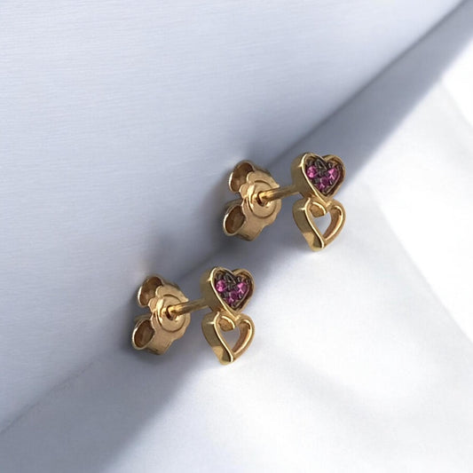 Elegant 14k yellow gold stud earrings featuring a double heart design, with one heart encrusted with small red stones.