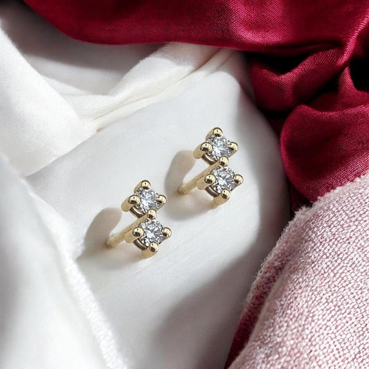 Minimalist 14k yellow gold stud earrings featuring two sparkling lab-grown diamonds in a sophisticated tiered setting.