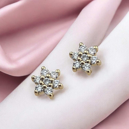 Elegant 14k yellow gold stud earrings featuring a delicate floral or star-shaped design encrusted with sparkling lab-grown diamonds.