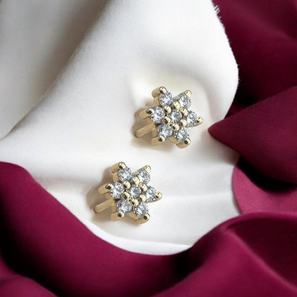 Elegant 14k yellow gold stud earrings featuring a delicate floral or star-shaped design encrusted with sparkling lab-grown diamonds.