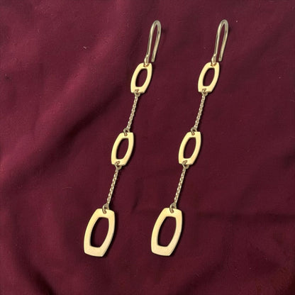 Modern 14k yellow gold chain drop earrings featuring elongated geometric open links with a polished finish.