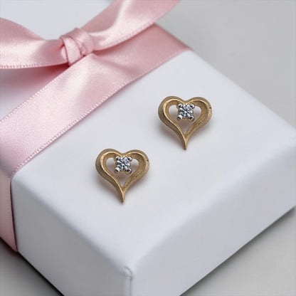 Elegant 14k yellow gold stud earrings featuring a delicate heart design with a sparkling central cubic zirconia stone.