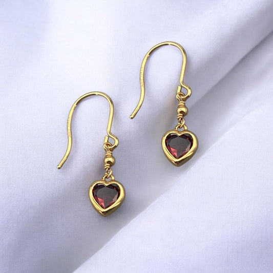 Elegant 14k yellow gold drop earrings featuring a delicate heart-shaped red garnet stone and a secure hook fastening.