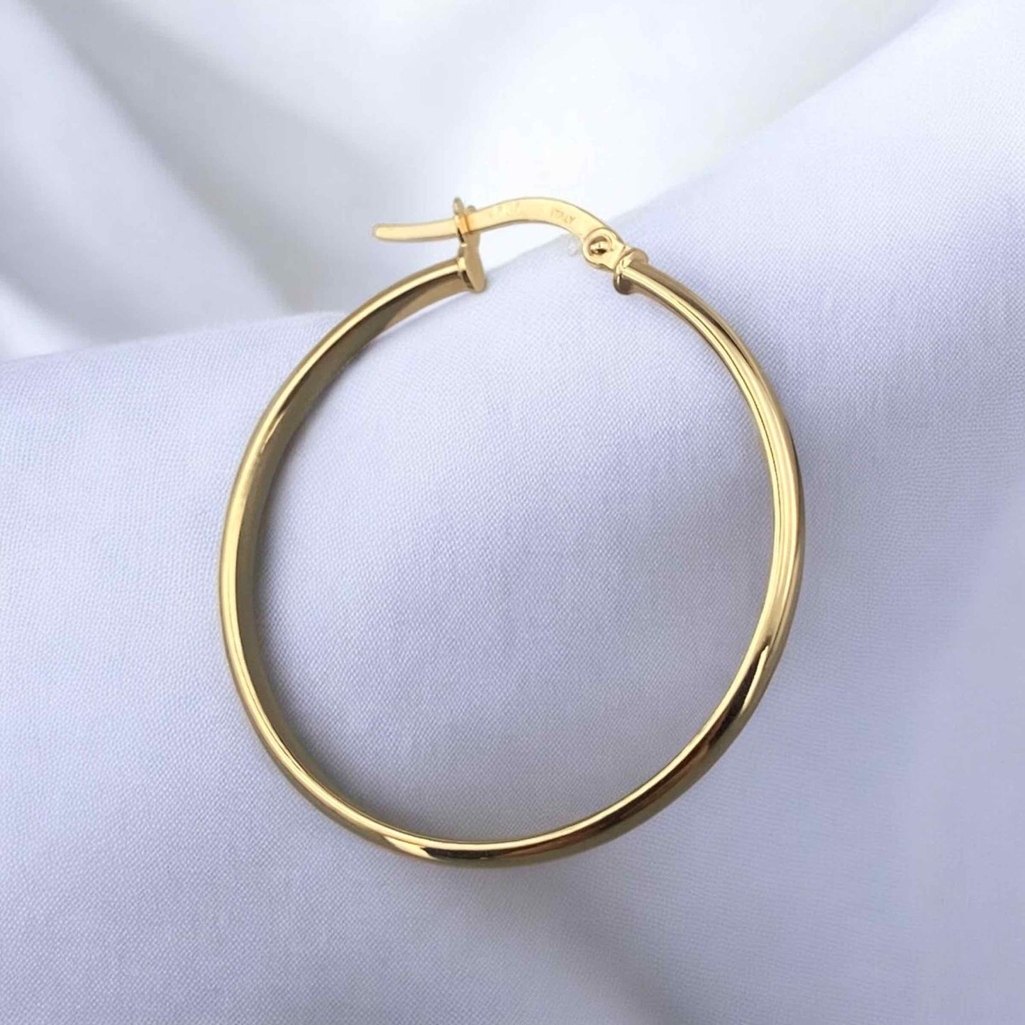 Elegant 14k yellow gold large hoop earrings with a classic round silhouette and polished finish.