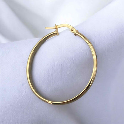 Elegant 14k yellow gold large hoop earrings with a classic round silhouette and polished finish.