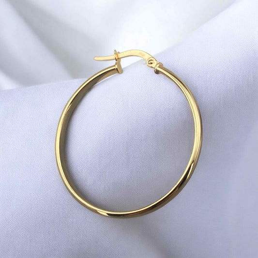 Elegant 14k yellow gold large hoop earrings with a classic round silhouette and polished finish.