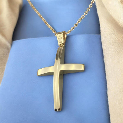 A 14K yellow gold men's cross pendant featuring a unique and elegant center design detail.