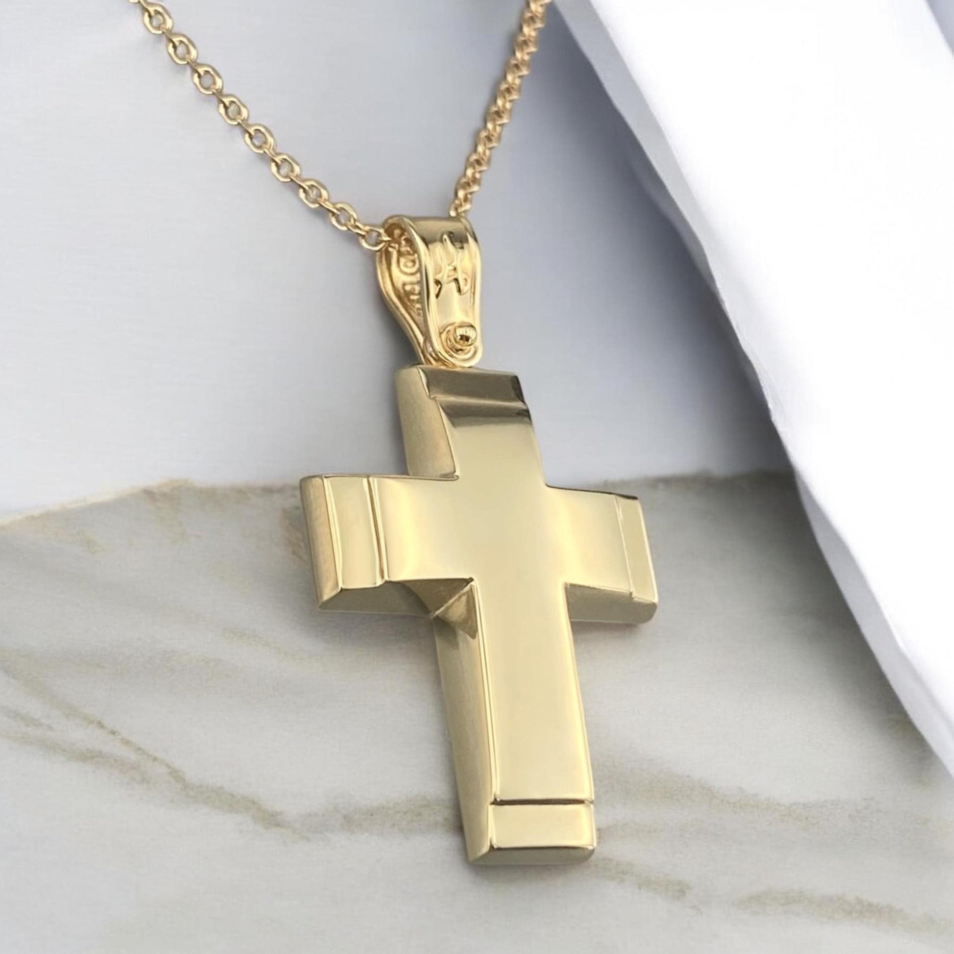 A 14K yellow gold men's cross pendant featuring a polished finish and distinct detailed edges.