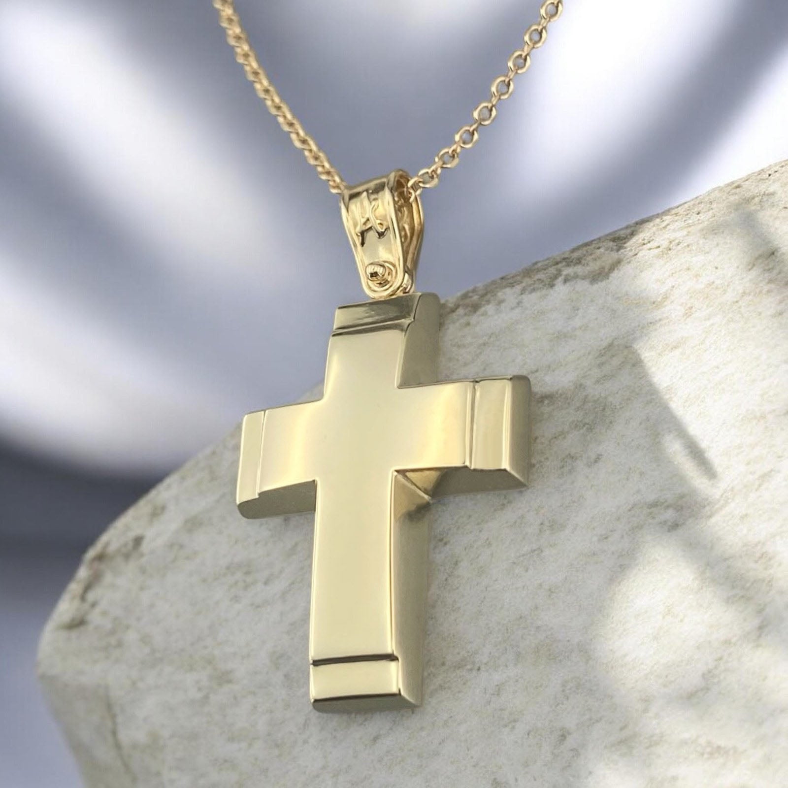 A 14K yellow gold men's cross pendant featuring a polished finish and distinct detailed edges.
