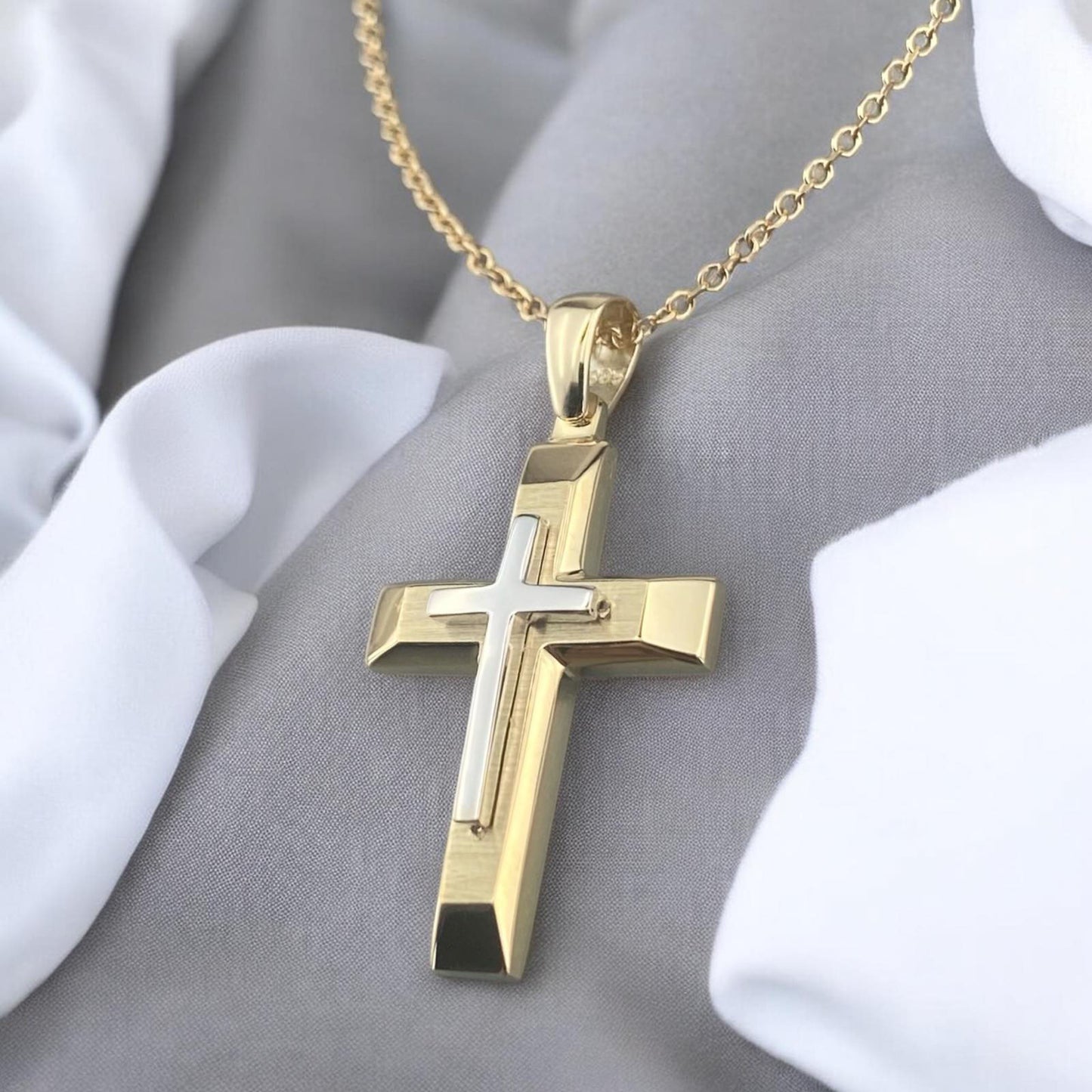 A 14K yellow gold men's cross pendant featuring a white gold inlay, combined with a unique matte and polished finish design.