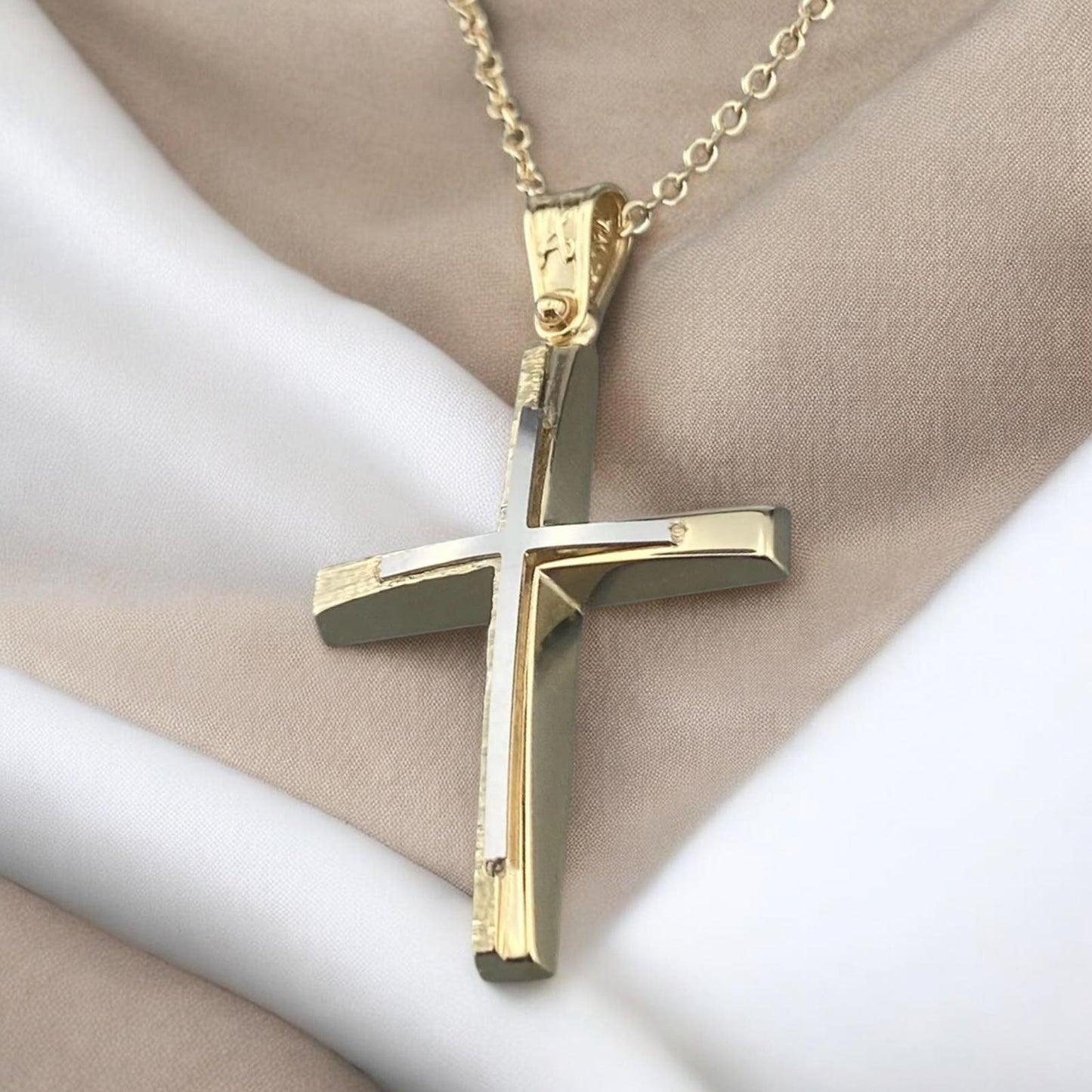 A 14K yellow gold men's cross pendant featuring a white gold inlay, combined with a unique matte and polished finish design.