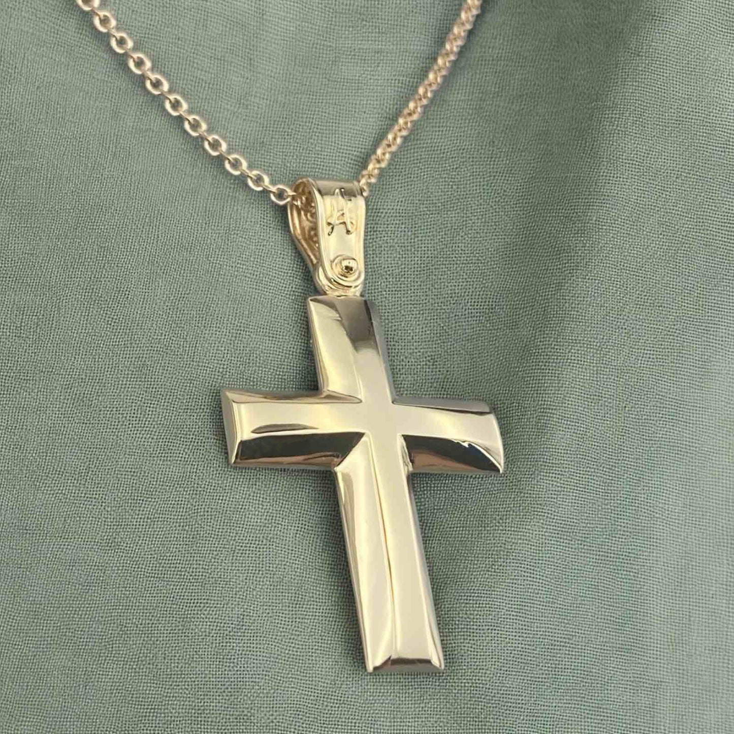 A 14K yellow gold men's cross pendant featuring a smooth, high-shine polished surface.