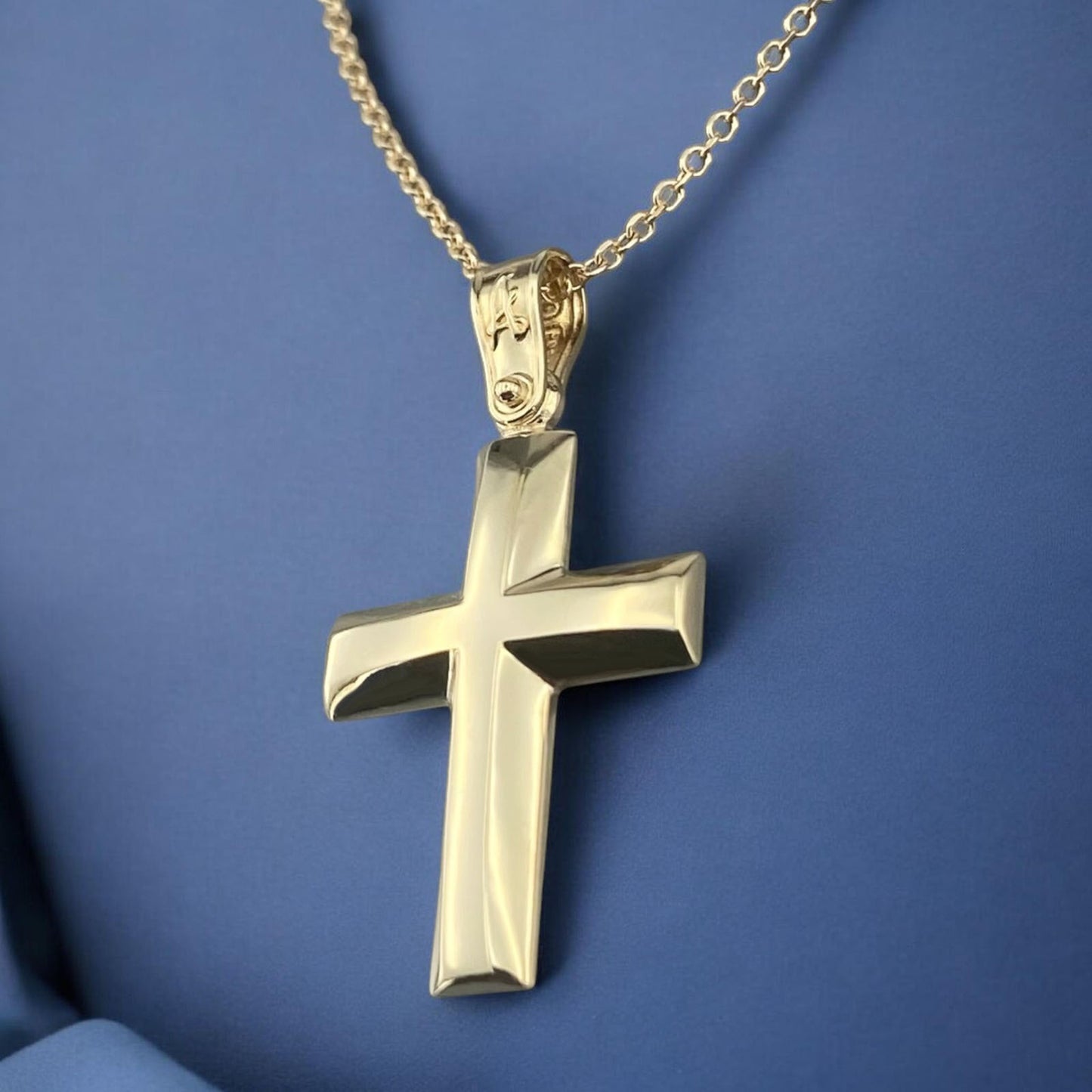 A 14K yellow gold men's cross pendant featuring a smooth, high-shine polished surface.