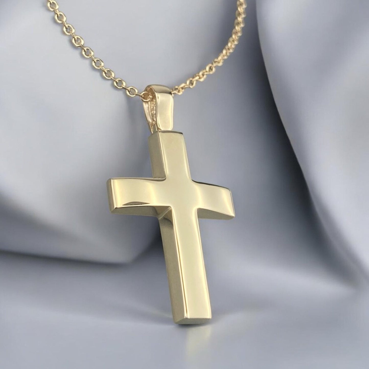 A 14K yellow gold men's cross pendant featuring a smooth, high-shine polished finish.