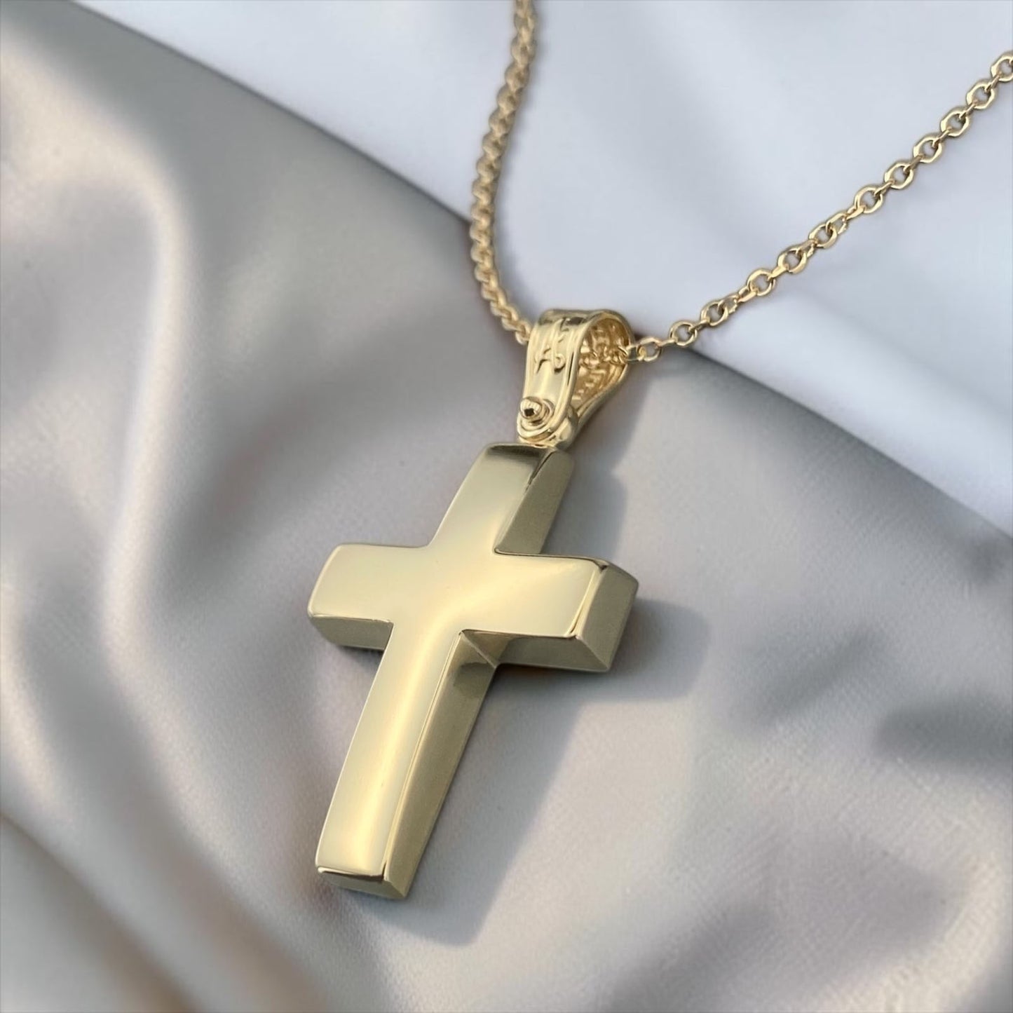 A 14K yellow gold men's cross pendant featuring a smooth, polished high-shine surface.