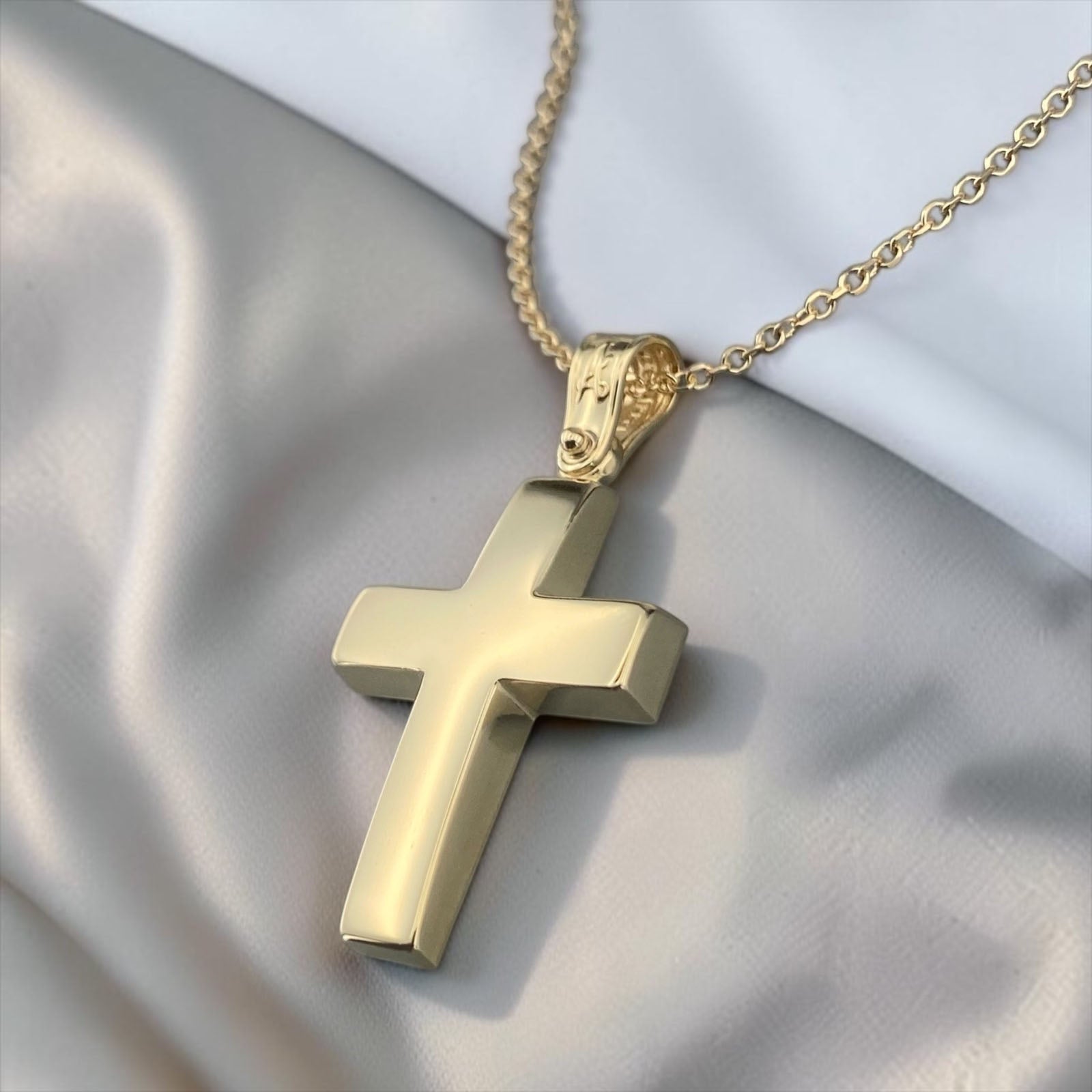 A 14K yellow gold men's cross pendant featuring a smooth, polished high-shine surface.