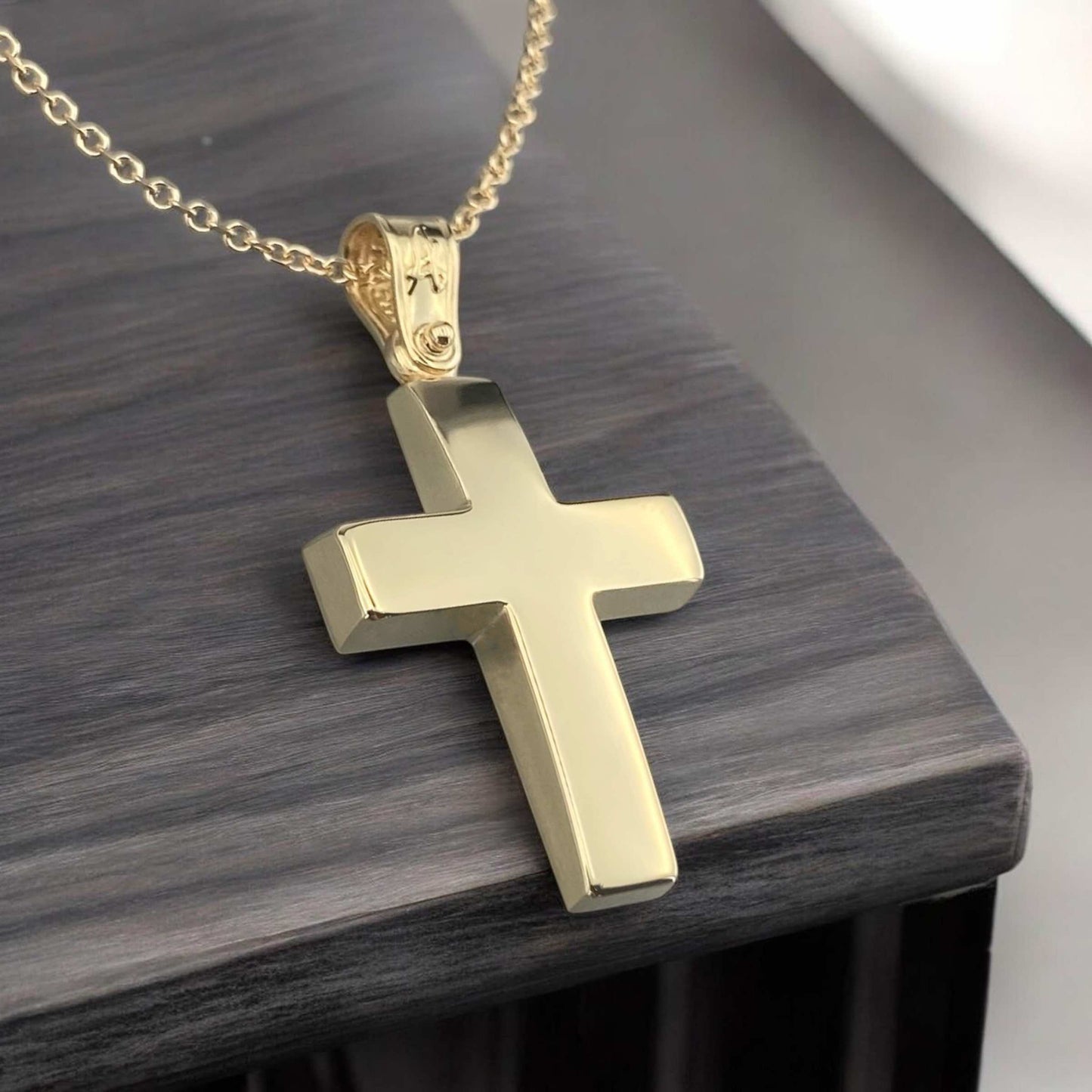 A 14K yellow gold men's cross pendant featuring a smooth, polished high-shine surface.