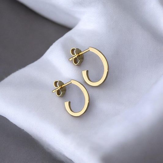 Modern 14k yellow gold half hoop earrings with a minimalist open design.