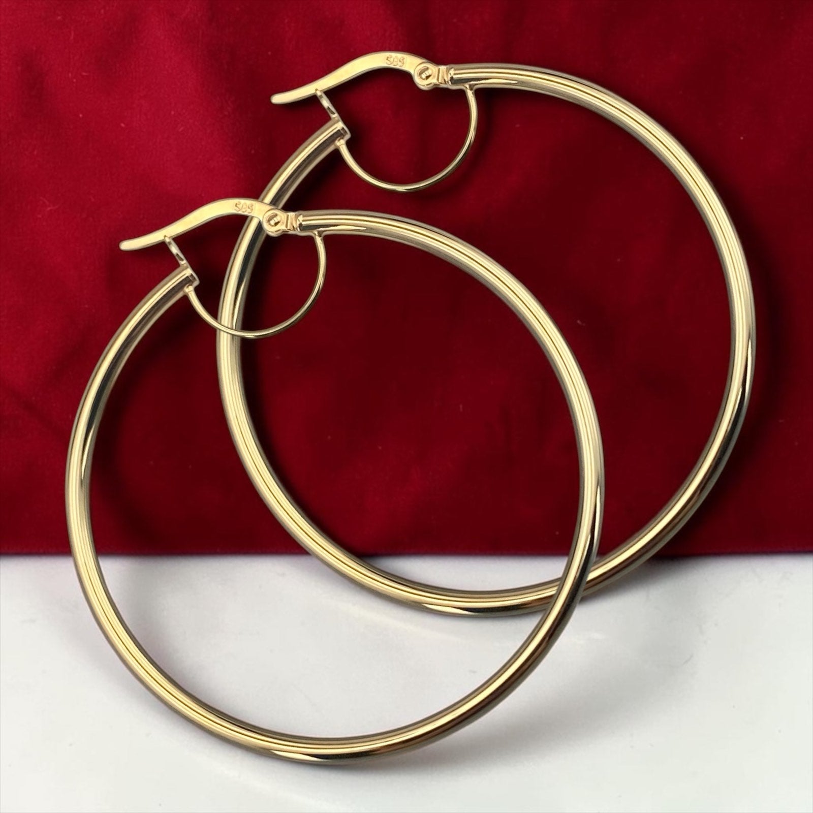 Elegant 14k yellow gold thin hoop earrings with a sleek minimalist round design and polished finish.