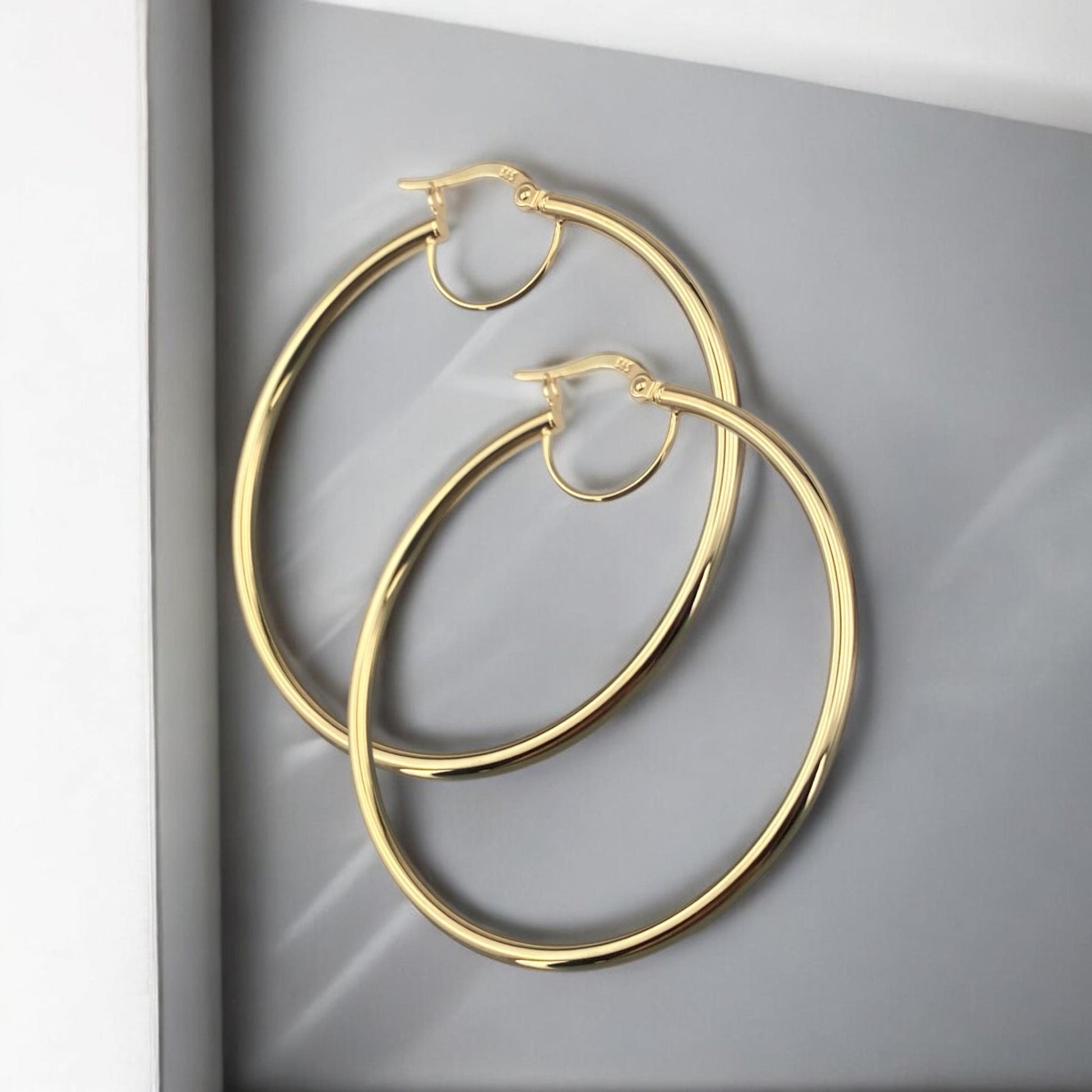 Elegant 14k yellow gold thin hoop earrings with a sleek minimalist round design and polished finish.
