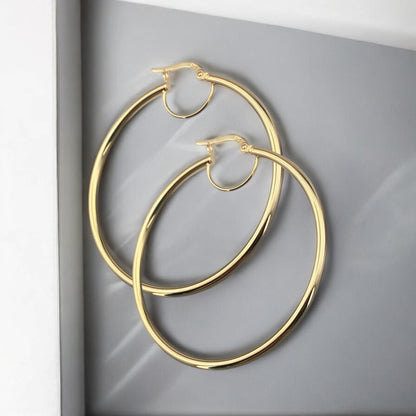 Elegant 14k yellow gold thin hoop earrings with a sleek minimalist round design and polished finish.