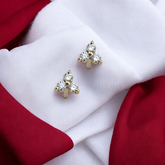 Elegant 14k yellow gold stud earrings featuring a delicate trio arrangement of sparkling lab-grown diamonds.