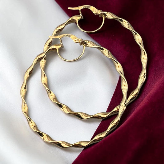 Stylish 14k yellow gold large hoop earrings featuring a twisted textured design with an elegant polished finish.