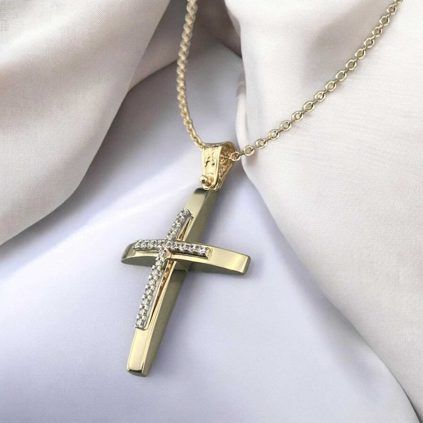 14K yellow gold cross pendant with white zirconia stones and a polished modern design