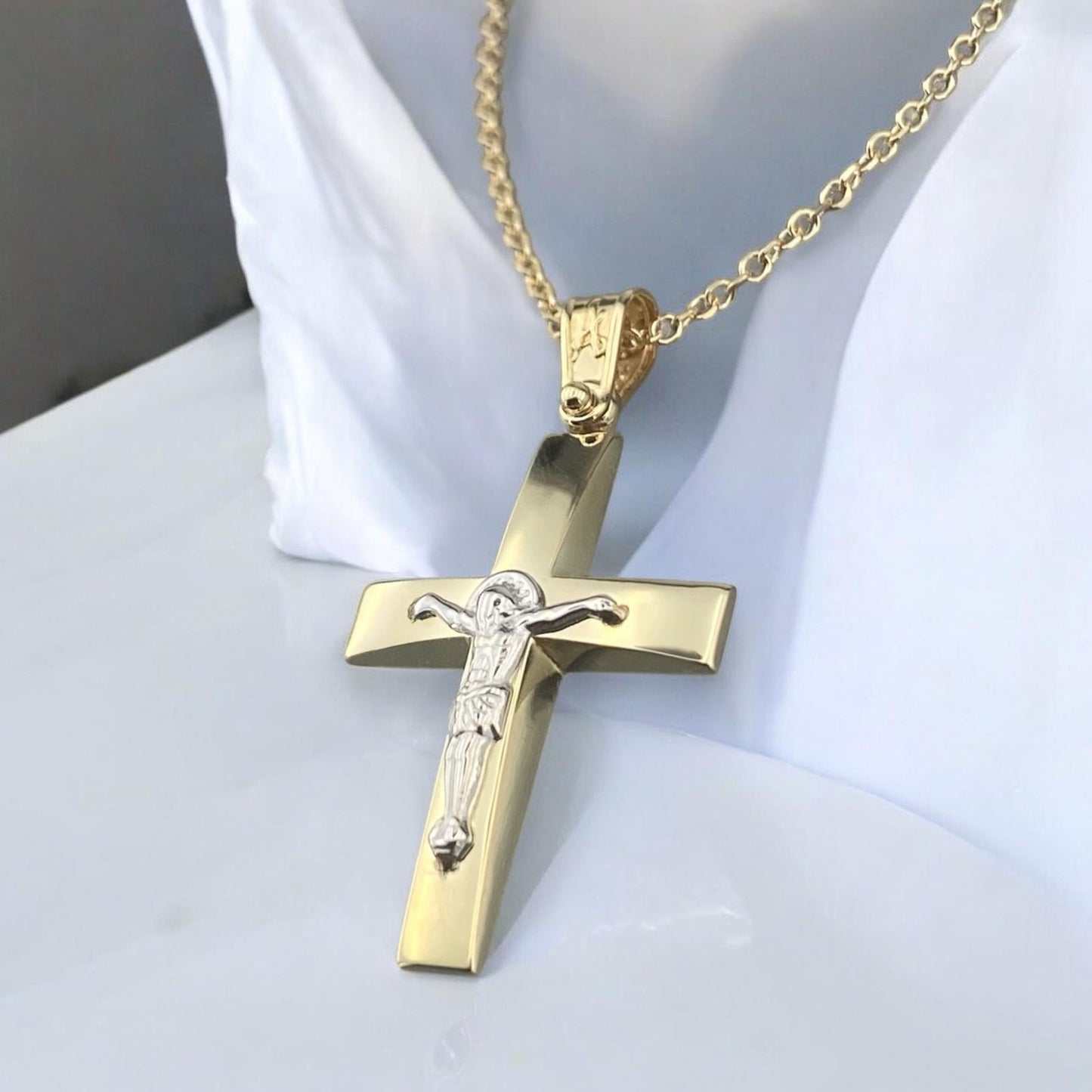 Men's 14K yellow gold cross pendant featuring a white gold crucifix and polished tapered design
