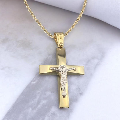 Men's 14K yellow gold cross pendant featuring a white gold crucifix and polished tapered design