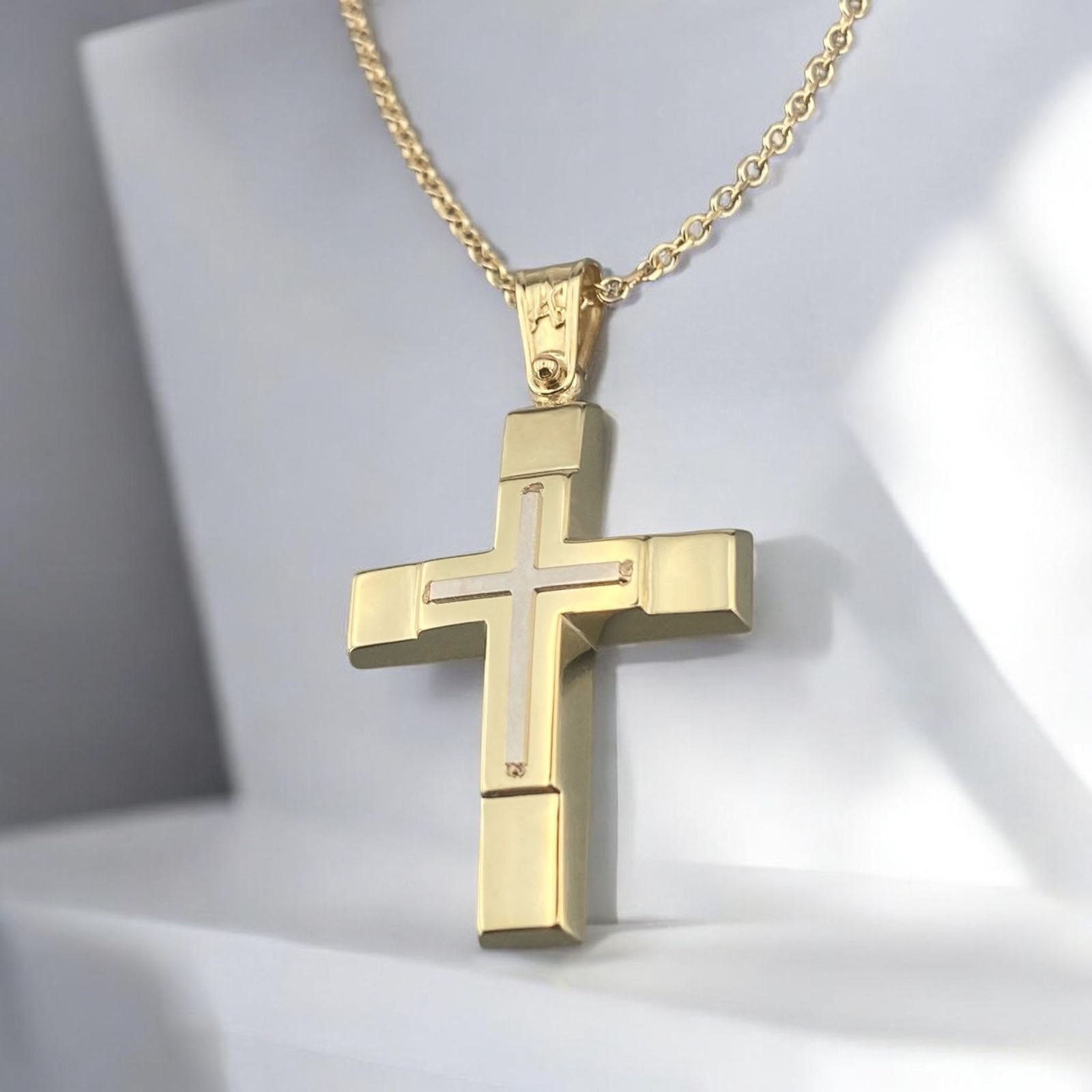 14K yellow and white gold men's cross pendant featuring a white gold inlaid cross and polished finish