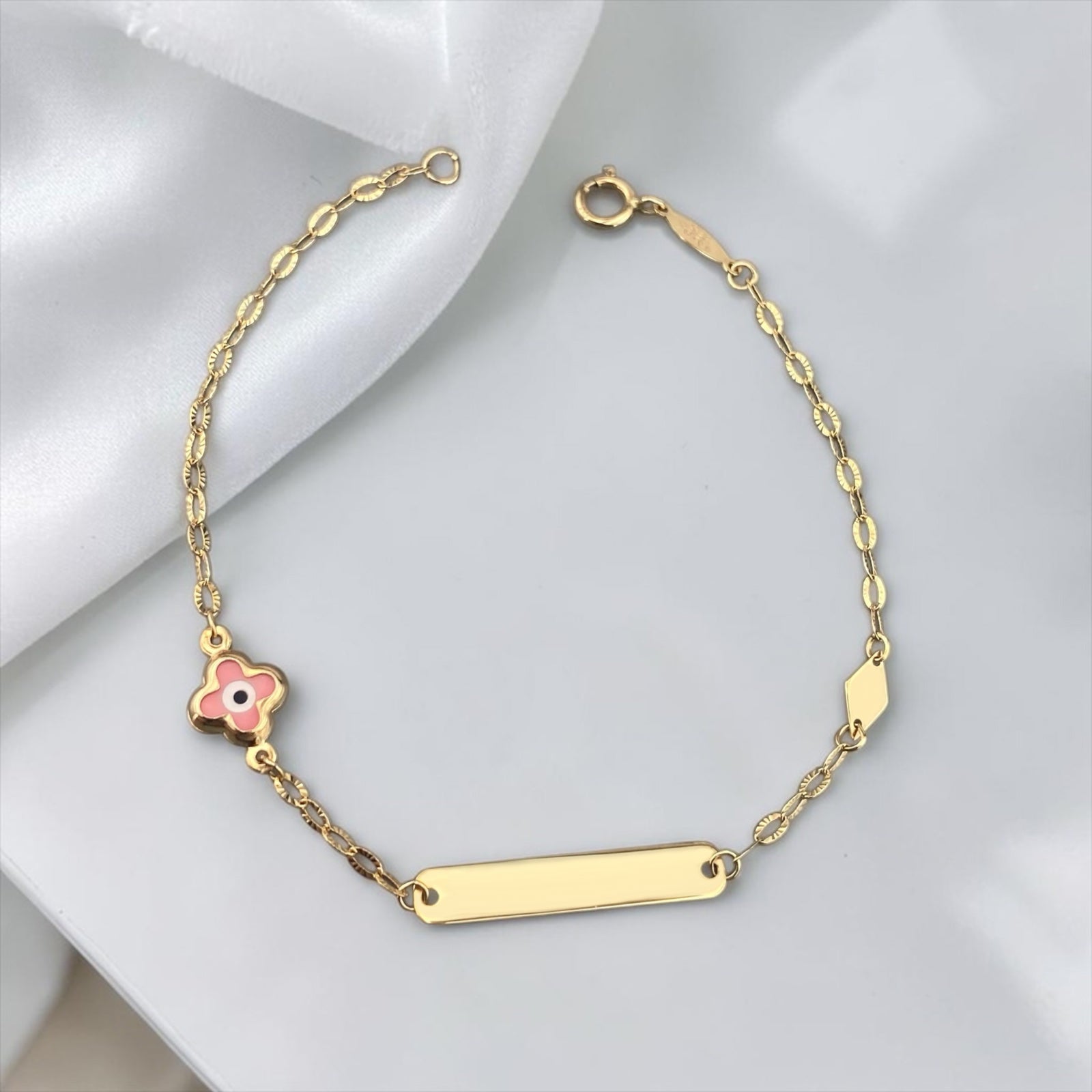 Children's 9k yellow gold ID bracelet featuring a clover-shaped pink eye charm, elegant baby jewelry.