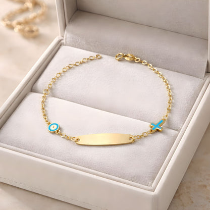 Children's 9k yellow gold ID bracelet featuring an blue eye charm and a cross charm, delicate baby jewelry.